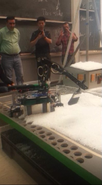 The arm reaching into the snow-covered test scene