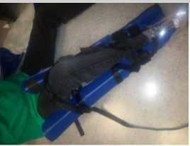 Origami-style folding splint strapped to a leg