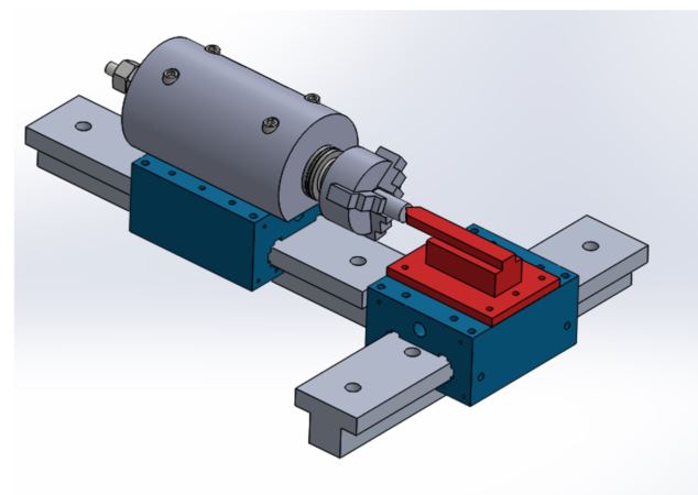 CAD overview of the whole lathe: the cylindrical spindle housing on its blue carriage riding one T-rail, with the three-jaw chuck facing the red tool holder on a second carriage on the perpendicular rail