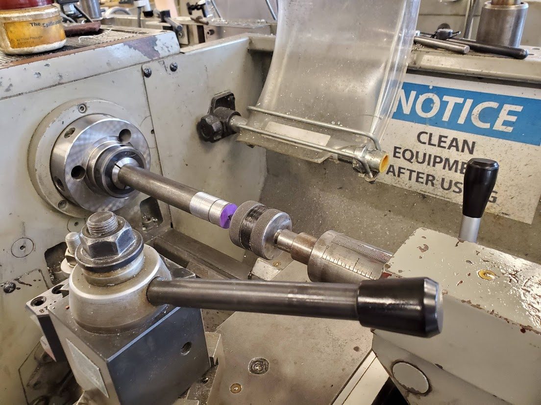 Cutting the thread on the end of the shaft with a die held in a tailstock die holder, the shaft gripped in a collet on the lathe spindle